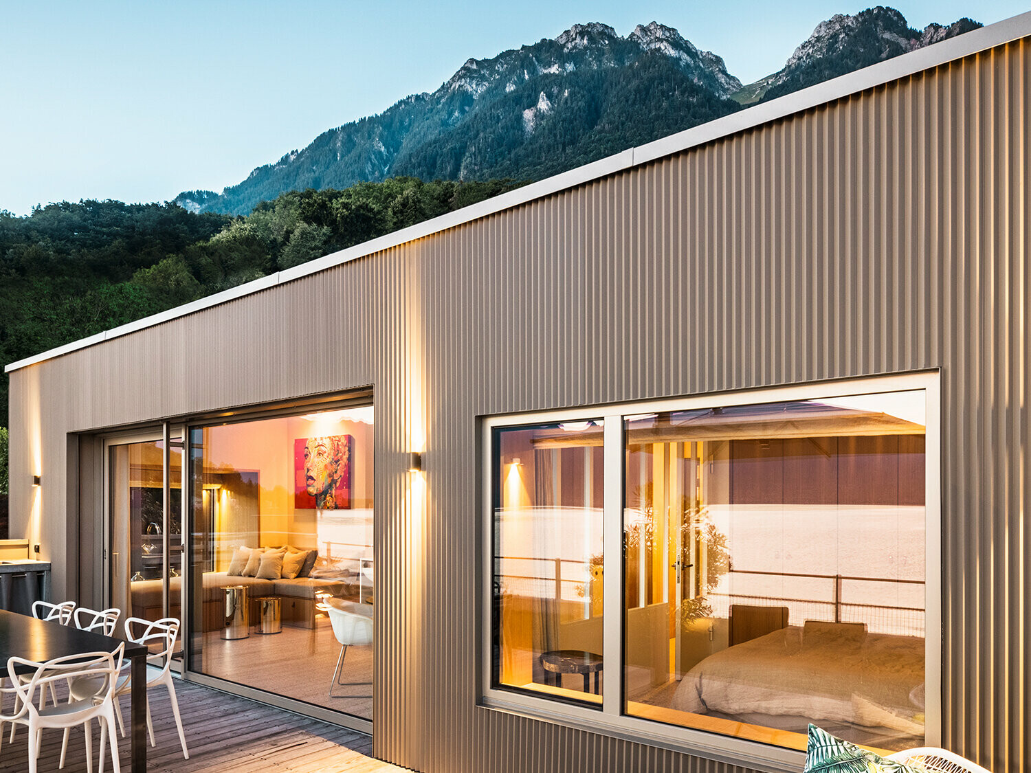 Pogled na terasu i dio unutrašnjosti zgrade u večernjim satima.