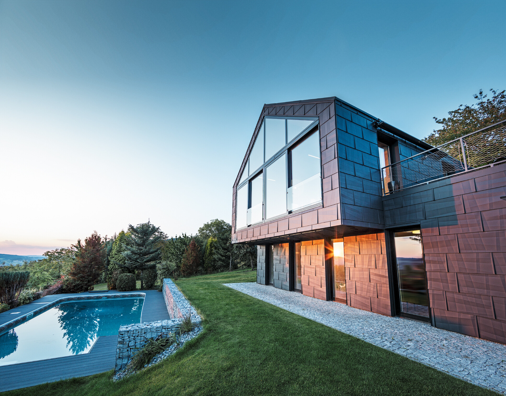 Aluminijska fasada obiteljske kuće s PREFA fasadnim panelima FX.12 u P.10 antracit boji u suton. 
