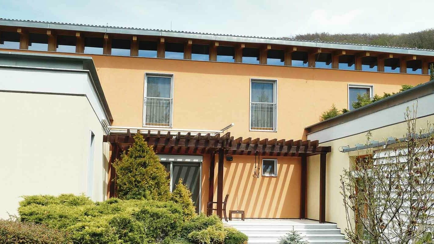 Moderna obiteljska kuća prije sanacije fasade PREFA fasadnim panelom FX.12 u P.10 antracit boji, narančasta fasada