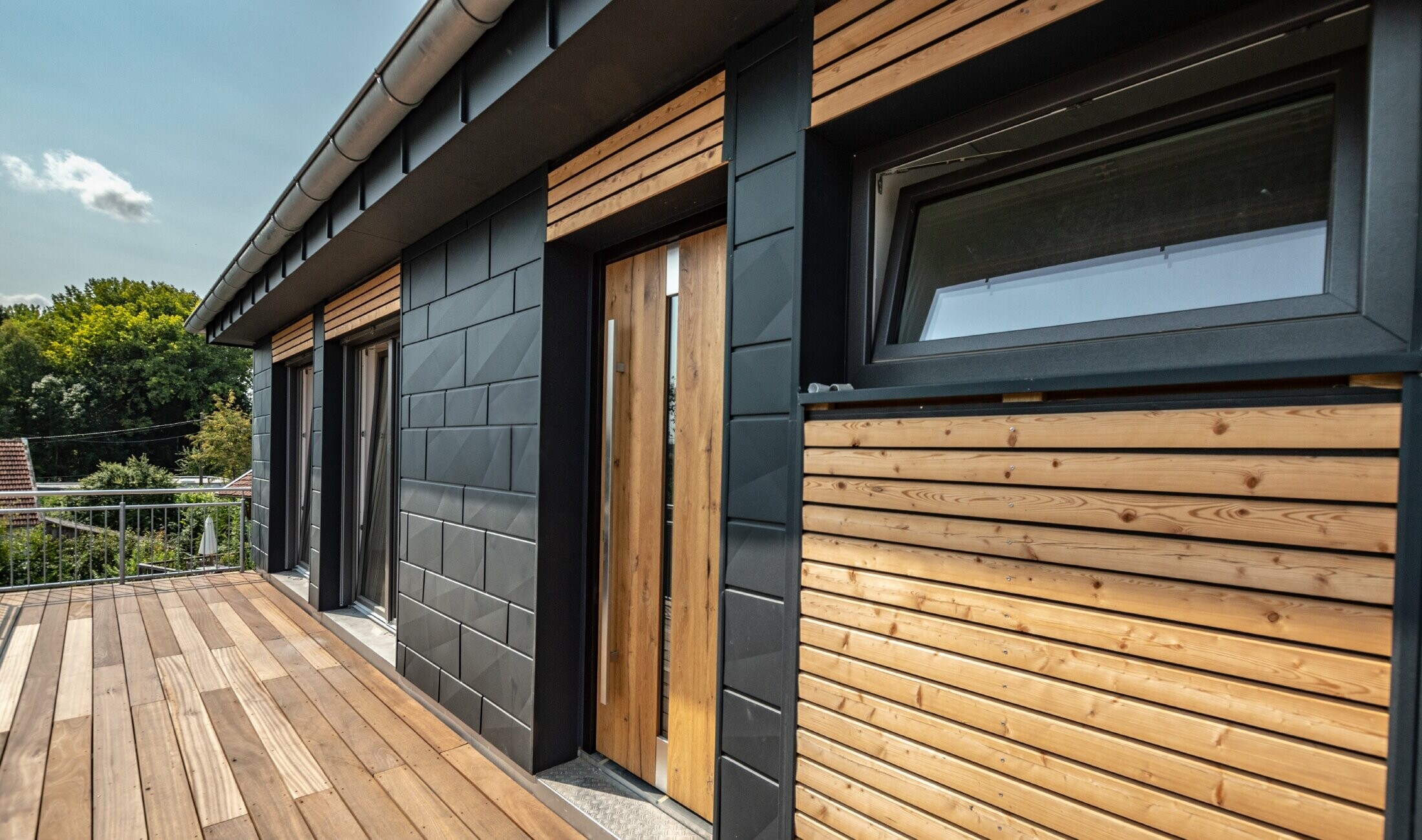 Oblikovanje fasade kombinacijom materijala aluminija - PREFA Siding.X u antracit boji - i horizontalnih drvenih letvi.